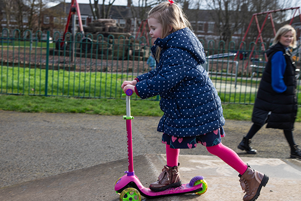 Child on a scooter in a playground